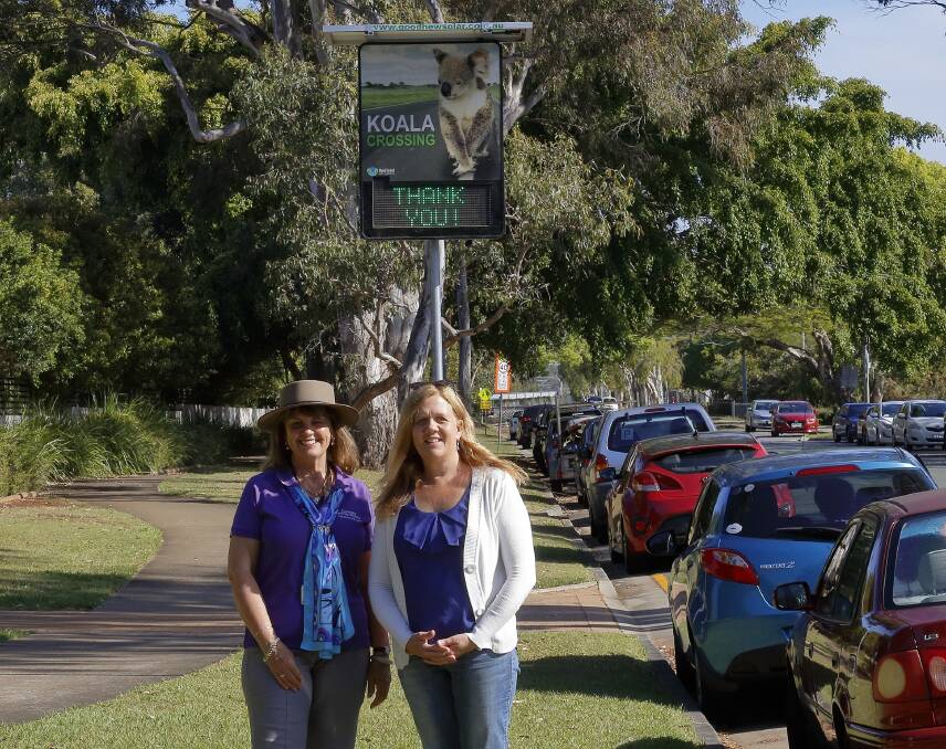INSTALLED: Cr Wendy Boglary and Koala Action Group president Deb Pointing stand underneath one of the new koala conservation area signs.