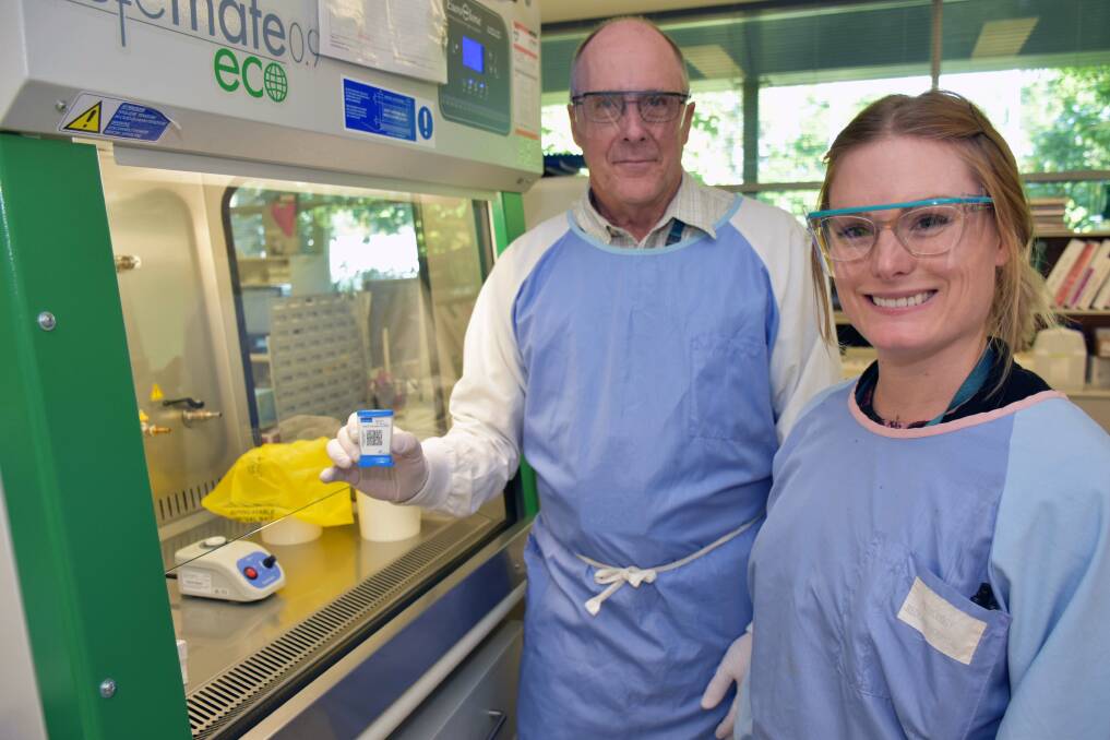 TESTING: Redland Hospital supervising scientist Greg Preeo and pathology scientist Kylie Stephenson test influenza samples.