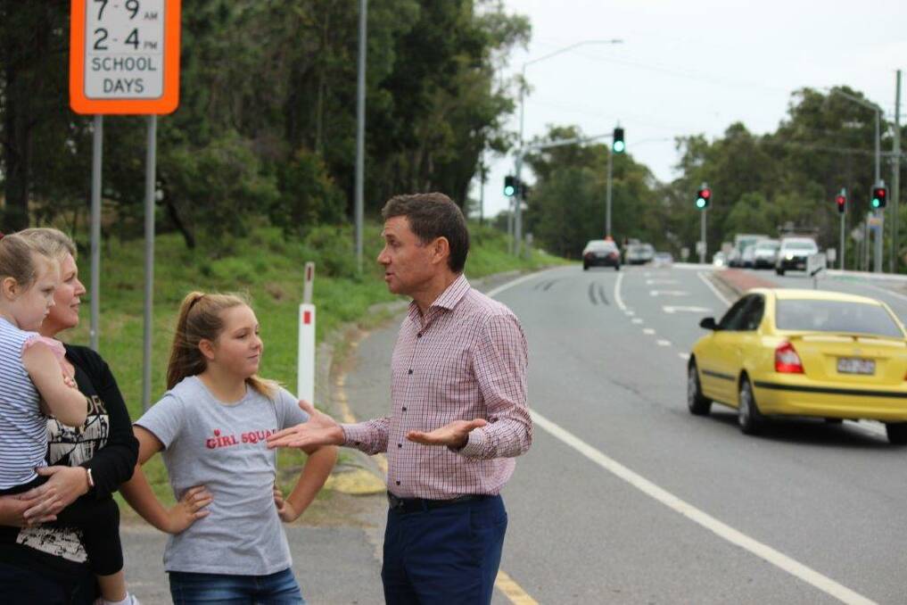 ROAD SAFETY: Andrew Laming chats to Rachael Baker Knijff, with her daughters Taylor, 11, and Sophie, 5, near the reduced speed zone on Mount Cotton Road.