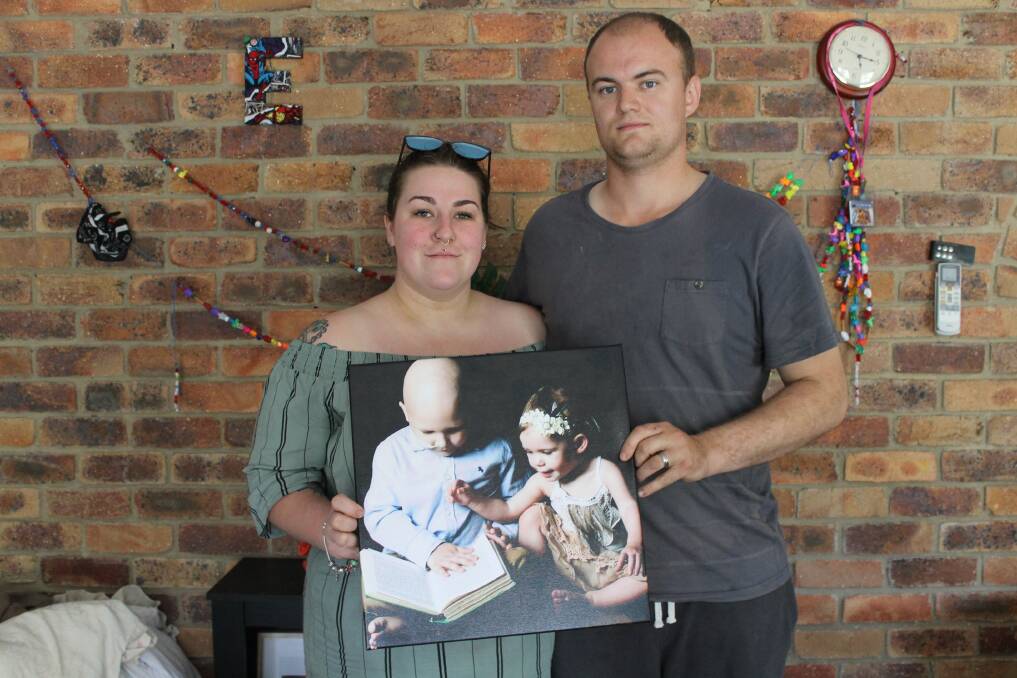 GOBSMACKED: Angie and Adam Mitchell hold a picture of their son Eddie and daughter Izzy. Photo: Cheryl Goodenough