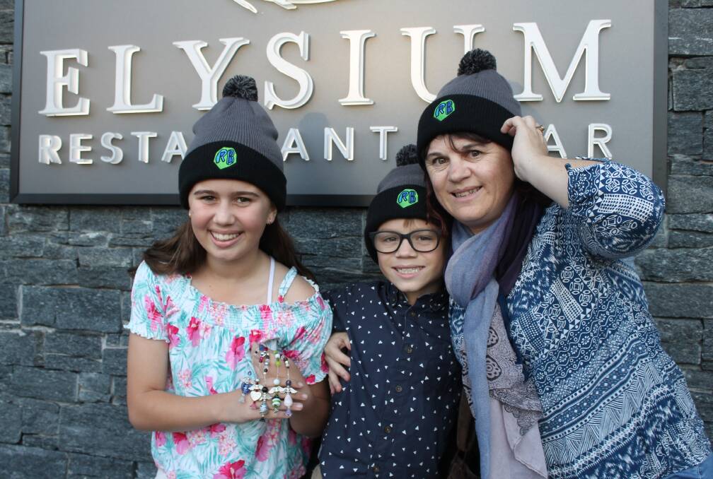 HELPING OTHERS: Maia, Ryley and Erin Ross with the beaded angels and beanies they will sell at the Beanies for Brain Cancer fundraiser at Elysium, Victoria Point. Photo: Cheryl Goodenough
