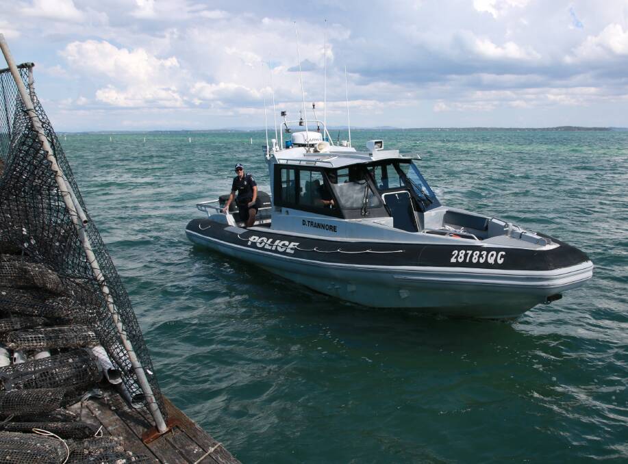 PATROL: Sergeant Paul Ryan and Senior Constable Jeff Benfer from Redland Bay Water Police patrol oyster leases off North Stradbroke Island.