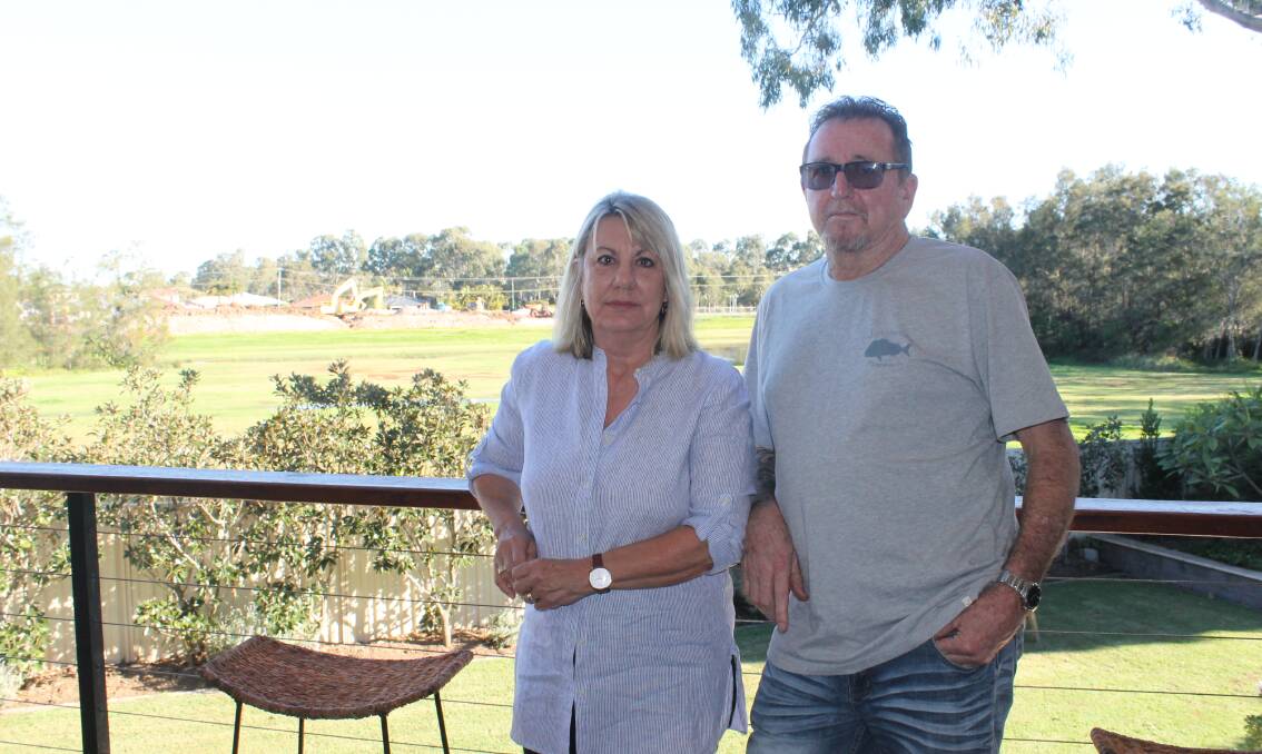 PDA RESIDENTS: Jocelyn and Mark Ball say that land behind their house in the priority development area at Weinam Creek will be ruined by a carpark. Photo: Cheryl Goodenough