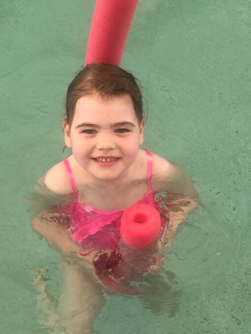 Poppy Morris learns swimming skills at YMCA Victoria Point.