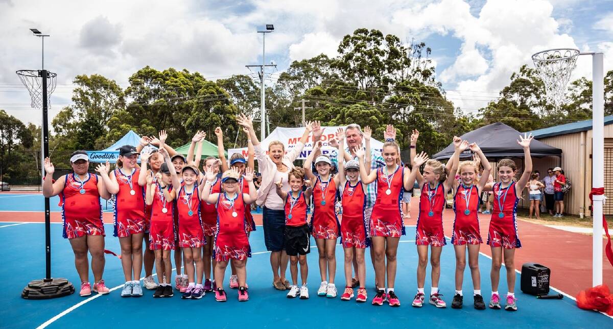 CHEERING: Mayor Karen Williams and Cr Murray Elliott with Meteors Netball Club players at the opening of the club’s renewed courts. Photo: Meteors Netball Club