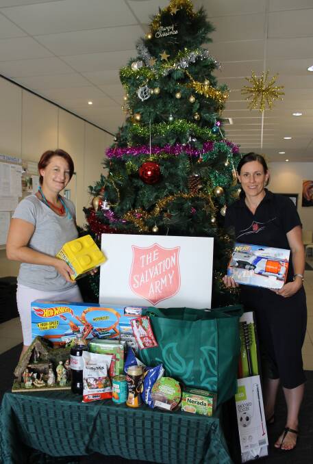 SHARING AT CHRISTMAS: Salvation Army volunteer Tamara Smith with Bayside Salvation Army leader Natalie Frame get food and gifts ready to share with families in need. Photo: Cheryl Goodenough