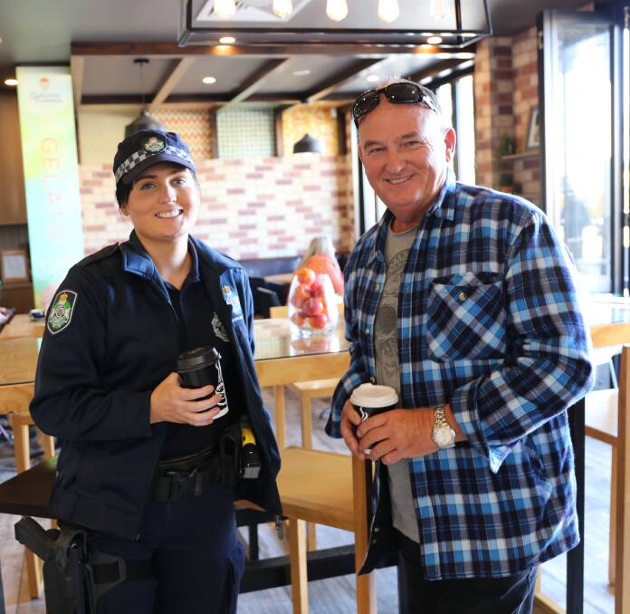 CHATTING: South Brisbane District Crime Prevention Unit Constable Steph Randolf with resident Ray Hanes enjoy a relaxed chat over a cup of coffee. Photo: Jocelyn Garcia