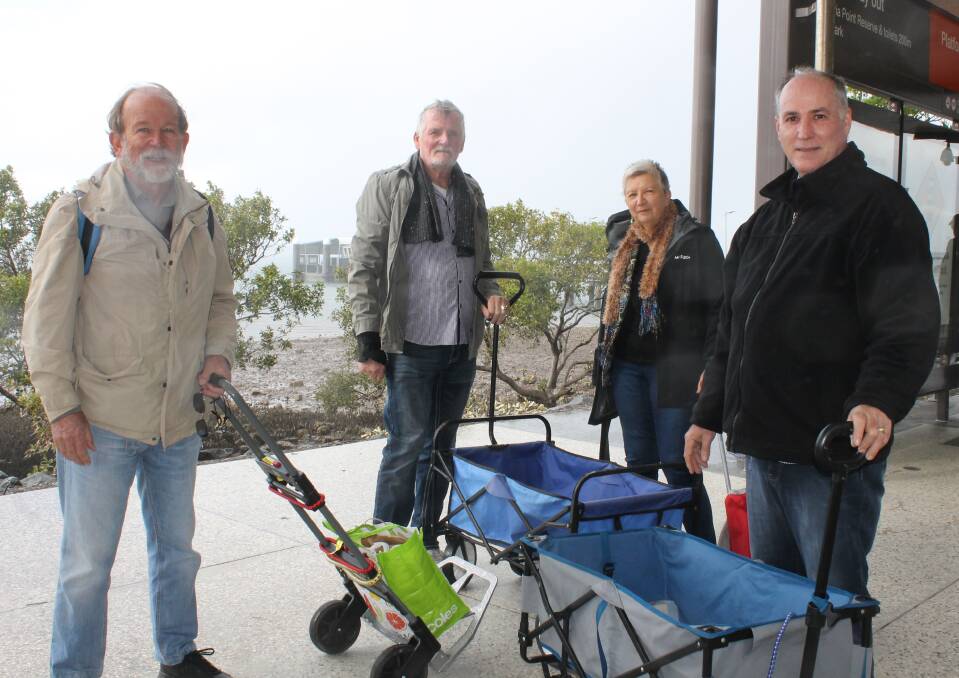 CALL FOR DELIVERY: Coochiemudlo Island residents Bill Narnst, Rob Martin, Heather Eckersley and Jon Woodworth with the trolleys they use to transport groceries home from the mainland. Photo: Cheryl Goodenough