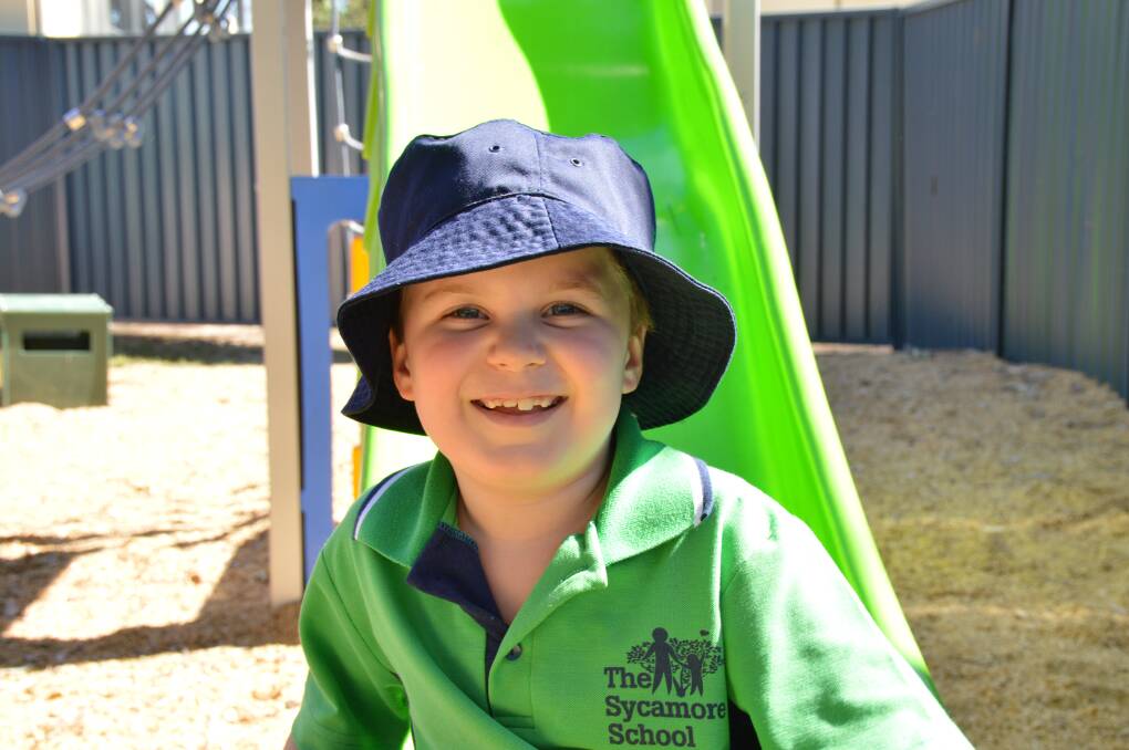 ALL SMILES: Sycamore School student Finn Cuppitt is all smiles in the school playground.