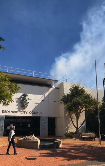 Smoke comes from the top of the Redland City Council building on Saturday.