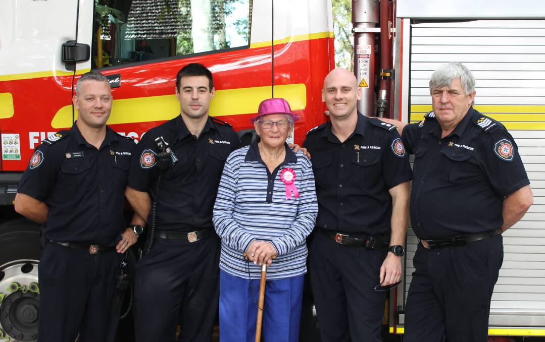 TICKLED PINK: Cleveland's Win Collins got a surprise when firefighters John Black, James Ryan, Josh Alpin and Graham Morrisby, from Cleveland station, popped by to wish her a happy 90th birthday. Photo: Cheryl Goodenough