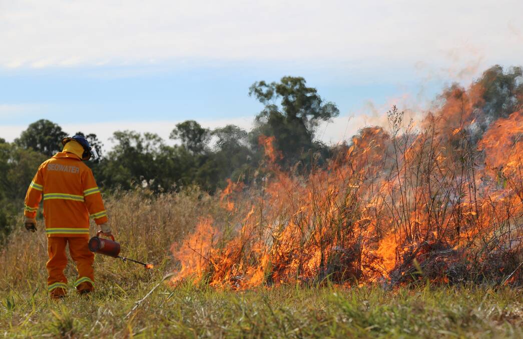 PLANNED: Seqwater ranger Scott Daniells takes part in planned burn. Photo: Seqwater