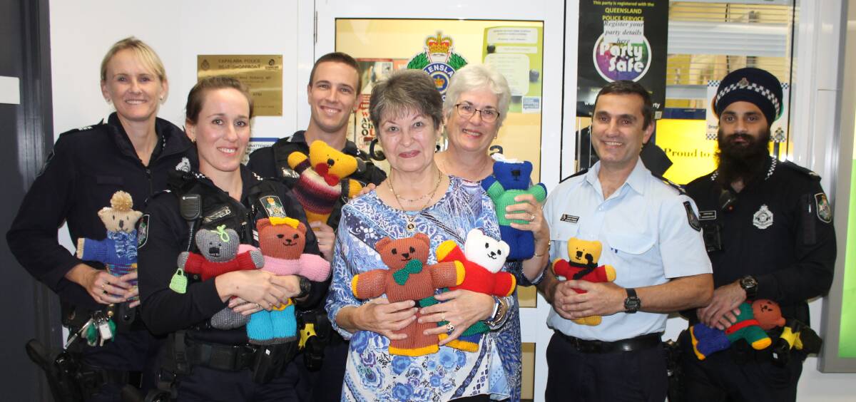 COLLECTING TEDDIES: Acting Sergeant Debra Bell, Senior Constable Vrinda McCauley, Constable Reece Jarman, knitters Rita Metcalfe and Sue Sykes, Senior Sergeant Dave Candale and Constable Sukhwinder Singh with teddies donated for the Cops Care Teddies project. Photo: Cheryl Goodenough 