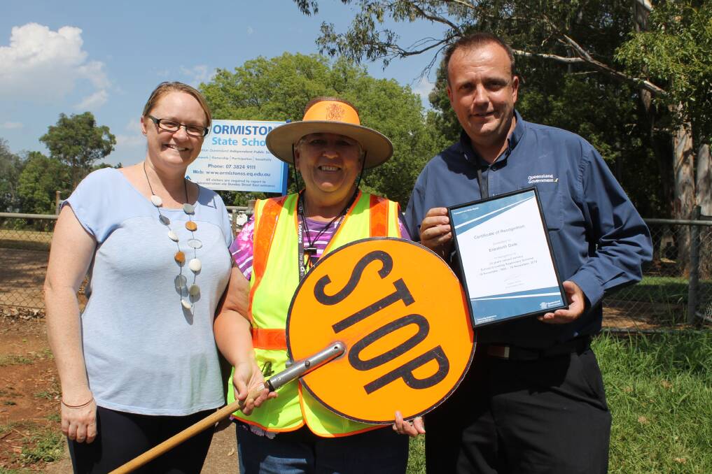 ACHIEVEMENT: Ormiston State School acting principal Jackie Wilkins with crossing supervisor Betty Dale and Transport and Main Roads road safety officer Graham Smith. Photo: Cheryl Goodenough