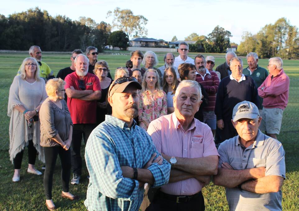 PROTESTING: Redland Bay residents are unhappy about the impact of a car park council plans to build on Moores Road land. Fronting the group are Steven Komorowski, Ian Mundey and Trevor Booton. Photo: Cheryl Goodenough