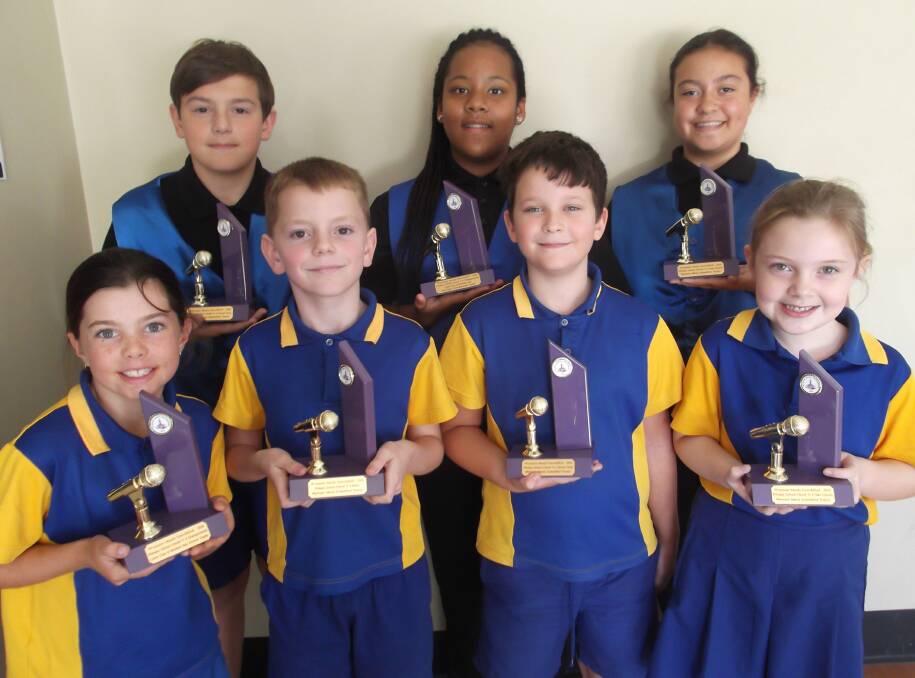 TROPHIES: Members of Birkdale State School's junior and senior choirs with the trophies they won at the Wynnum Manly Eisteddfod. Photo: Supplied