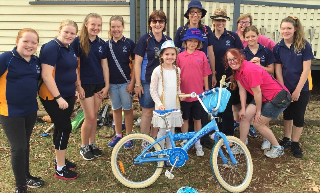 Members and leaders of the Victoria Point Girl Guide unit donated a bicycle to local girl Vanessa at their garage sale.