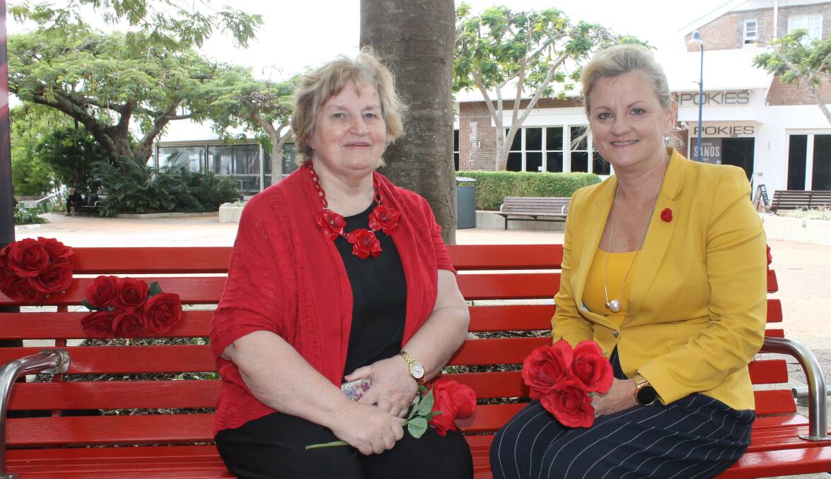 REMINDER: Red Rose Foundation chief executive Betty Taylor and Redland mayor Karen Williams on the red bench outside the Cleveland library. Photo: Cheryl Goodenough