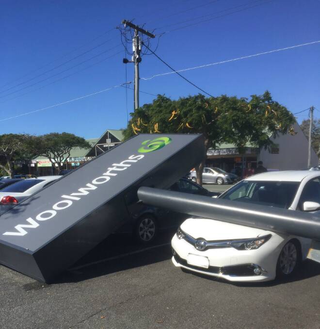 A shop sign has fallen onto vehicles in a car park at Cleveland.