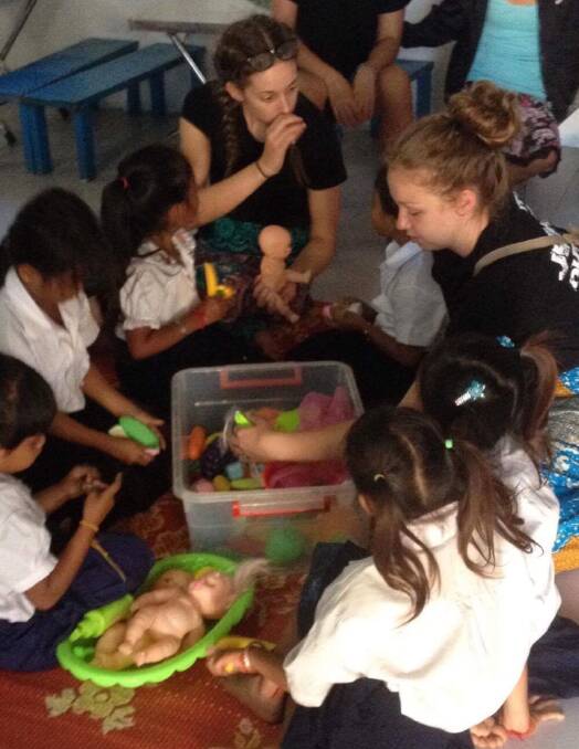 Emma (right) with children in Cambodia in late 2016.