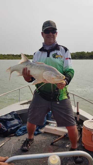 LURED IN: Jason May with a fat, lure caught, threadfin salmon.