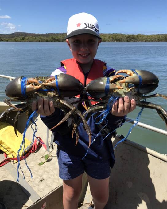 GREAT CRABS: Thomas Brehmer with a handful of mud crabs from Jumpinpin. 