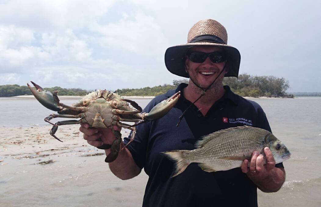 GOOD CATCHES: Shane White with a mud crab and 43cm bream from the Coomera River caught at the weekend. 