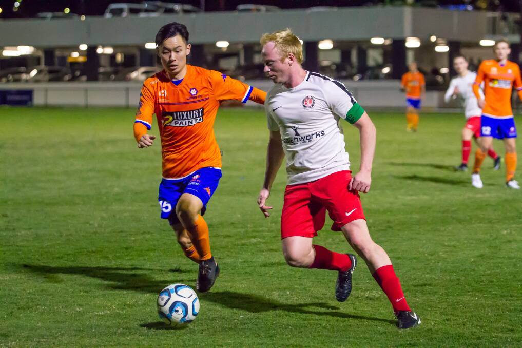 EYES ON THE BALL: Redlands Scott Sargent keeps the ball moving against Lions FC last Saturday evening.  Picture: Ray Gardner. 
