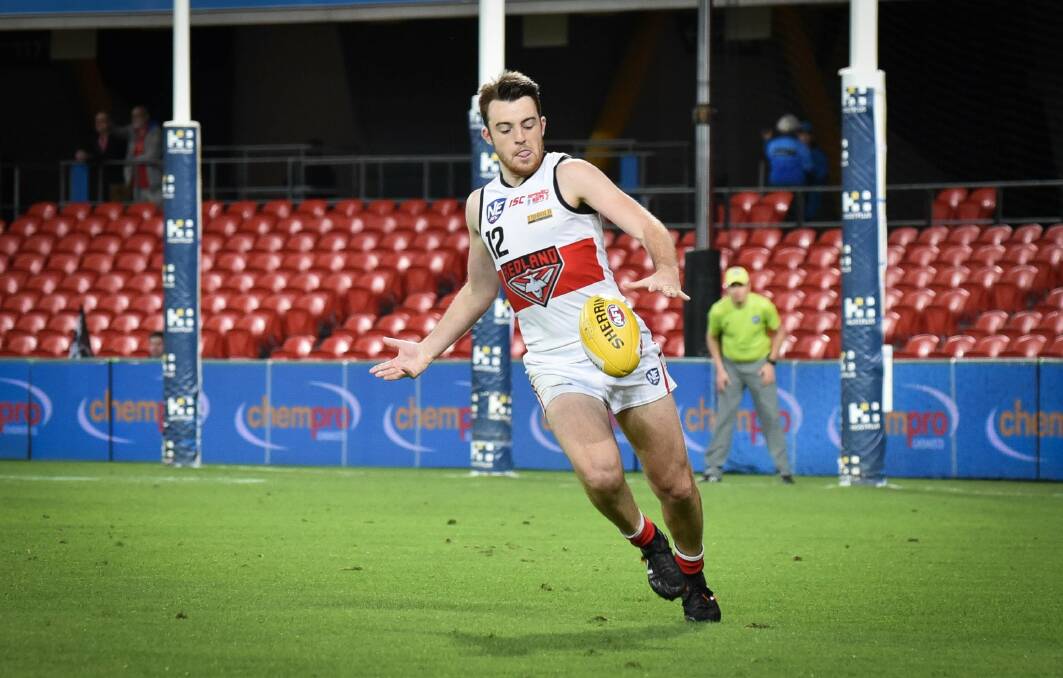 FROM THE WEEKEND: Scott Miller kicks for Redland Bombers. Photo: Highflyer Images