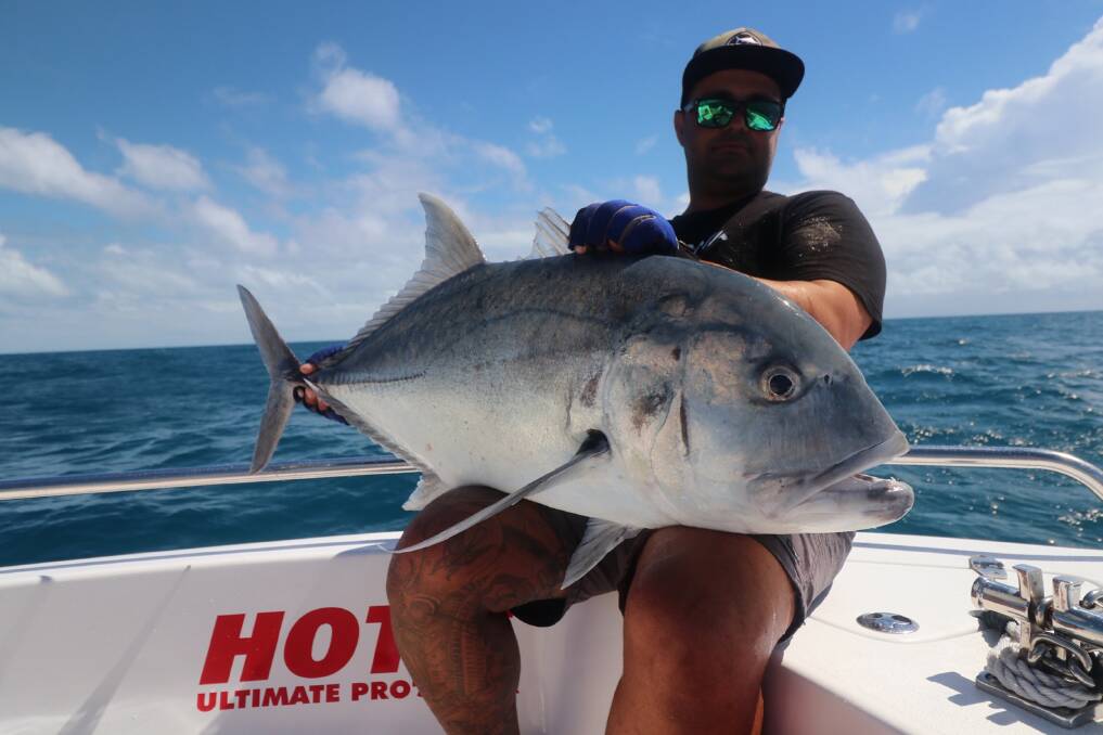 THAT'S A FISH: Greg Harriman with a giant trevally caught on a popper while holidaying in Cairns . Picture Supplied. 