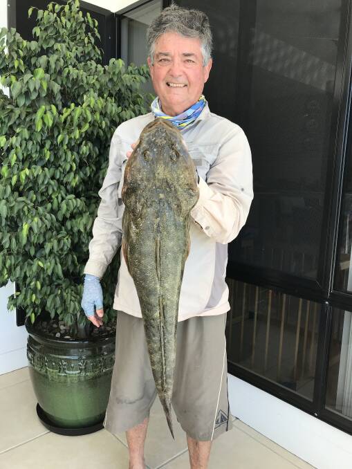 FLATHEAD: Graham Livingstone with a 74cm flathead caught on bloodworms off the southern end of Bribie Island. 
