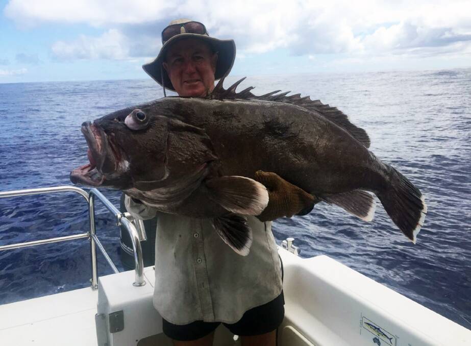 MONSTER GROUPER: Paul McCormack with a large bass grouper from 400m of water off the Gold Coast.