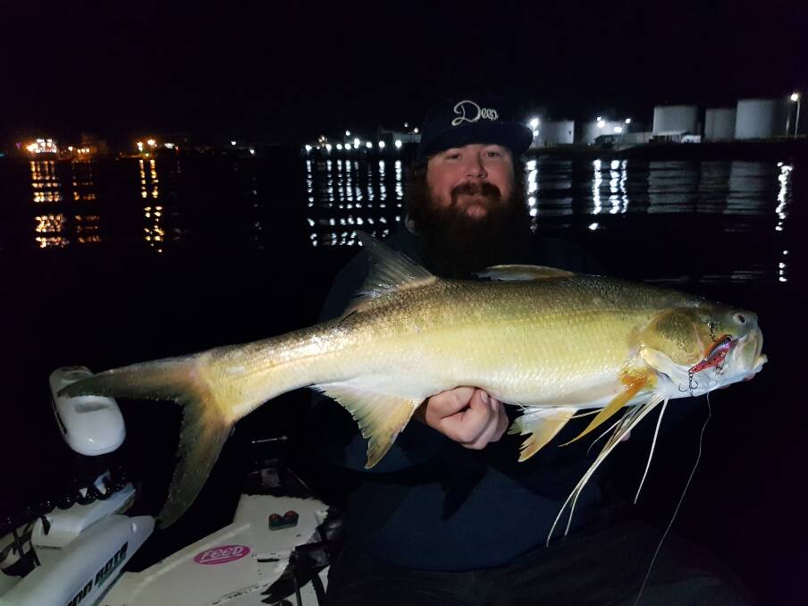 NIGHT FISH: Corey McMullen with a threadfin caught in the Brisbane River on an IMA Schneider vibration blade.