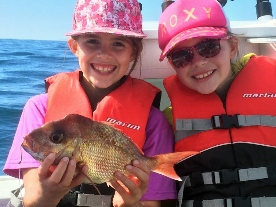 CATCH AND RELEASE: Sisters Elaina and Isabelle Hadegelias happy with their snapper, caught and released from Moreton Bay. 