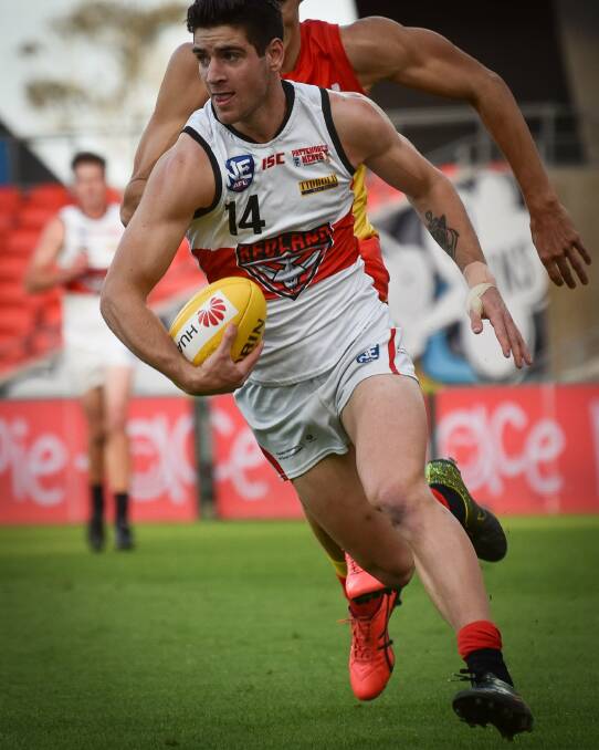 HARD LOSS: Jack Rolls with the ball for the Redlands. Photo: Highflyer Images
