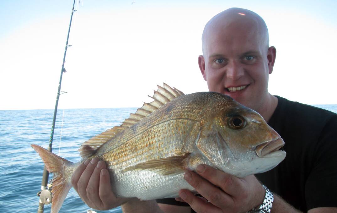 SNAPPED UP: World Number one darts champion Michael Vangerwen with a snapper caught on board Frenzy Charters.