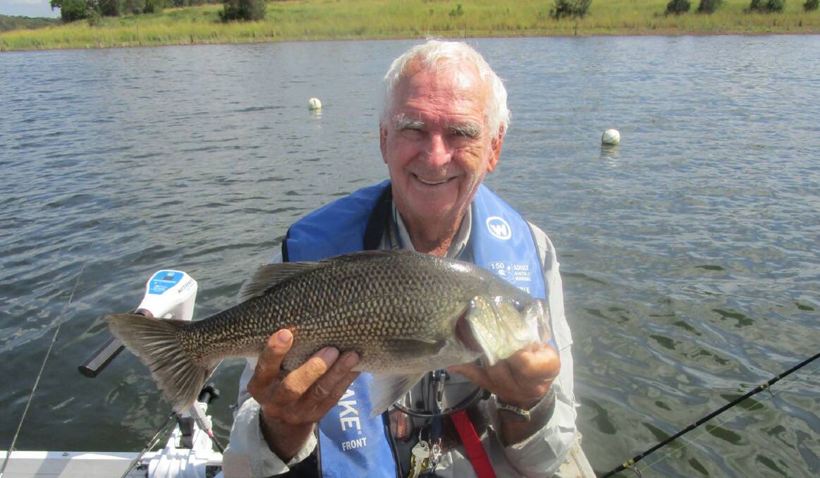 On the bite: Ray Kennedy is pictured with a solid bass he caught in Lake Samsonvale recently. 