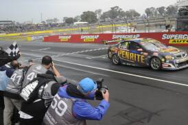 FIRST TIME WINNER: David Reynolds crosses the finish line to win a rain soaked edition of the Bathurst 1000. Photo: CHRIS SEABROOK 