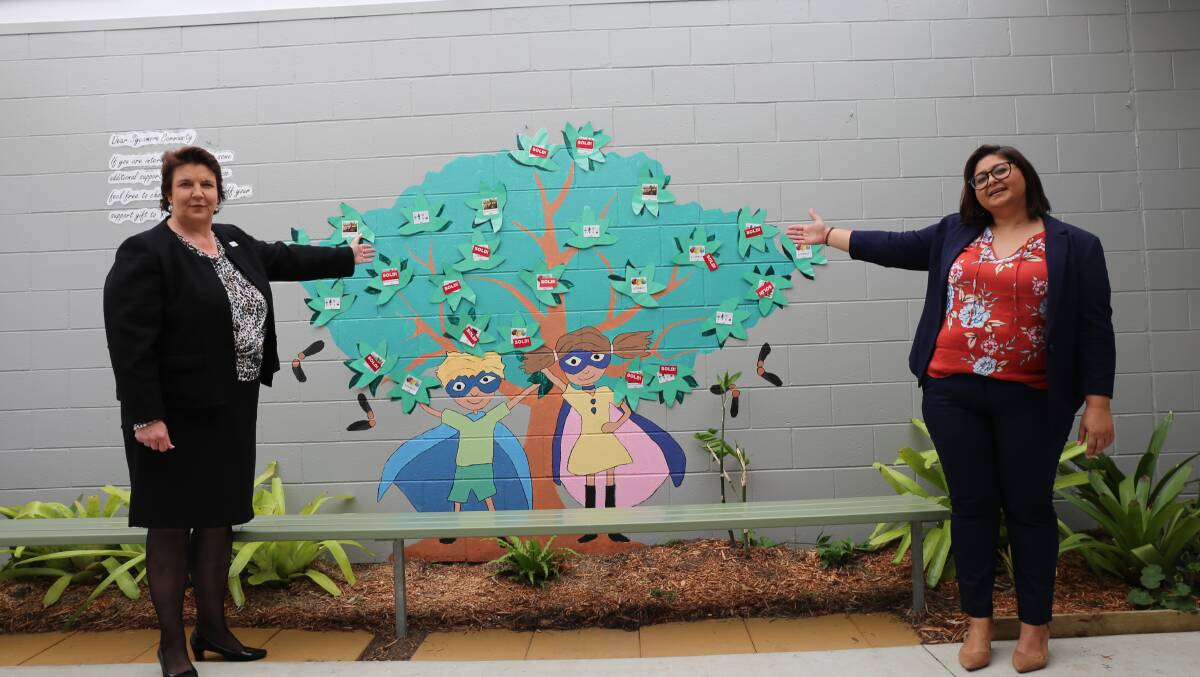 Sycamore School principal Bronwyn Collier and chief executive officer Cindy Corrie with their "sold" leaves after receiving funds towards school projects. Photo: Jocelyn Garcia