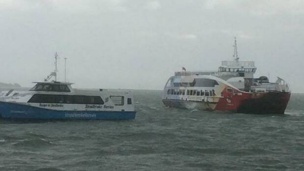 Stradbroke Ferries' Big red Cat ran aground just before low tide on Monday, stranding more than 200 holiday makers onboard overnight. Photo: Geneve Hague