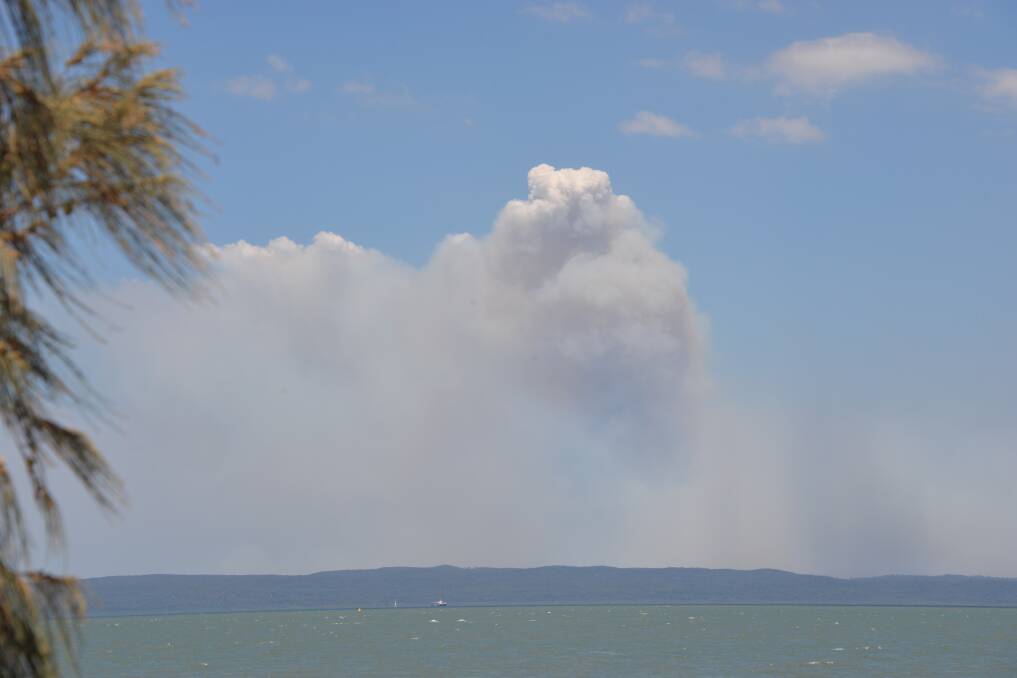 BUSHFIRE: The bushfire at North Stradbroke Island's Eighteen Mile Swamp has been contained but authorities have warned residents and visitors to the island to keep alert to safety messages from authorities. Photo: Brian Williams