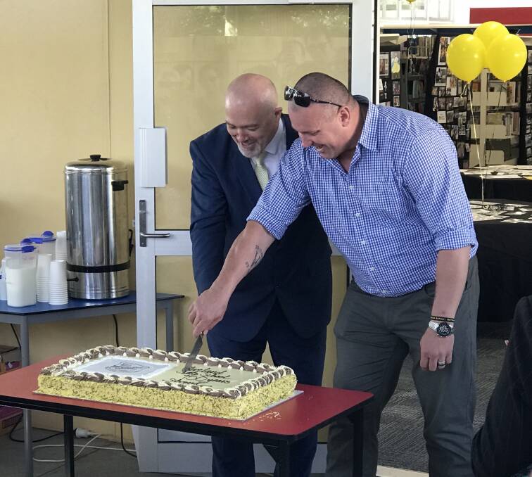 CELEBRATION: Cleveland State School principal Mark Ionn and P&C committee president Wolfgang Neszpor cut the school's 150-year birthday cake. Photo: Supplied