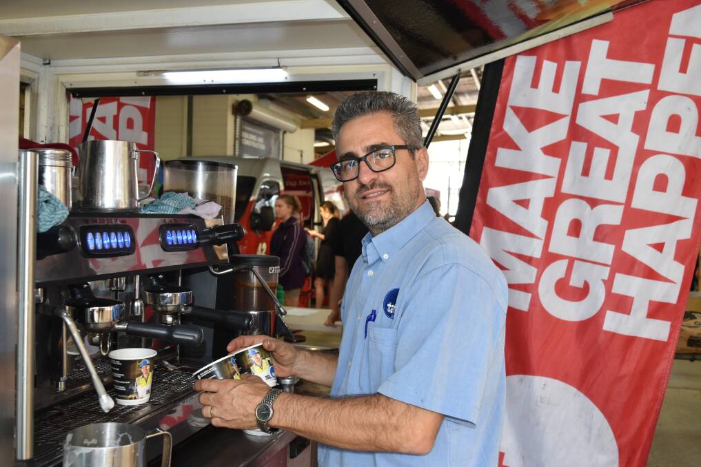 Business manager for stakeholder relations Bill Alexion making coffees. He said the coffee cart was taken out to different construction sites, offering free coffee and information about courses and apprentices. Photo: Hannah Baker