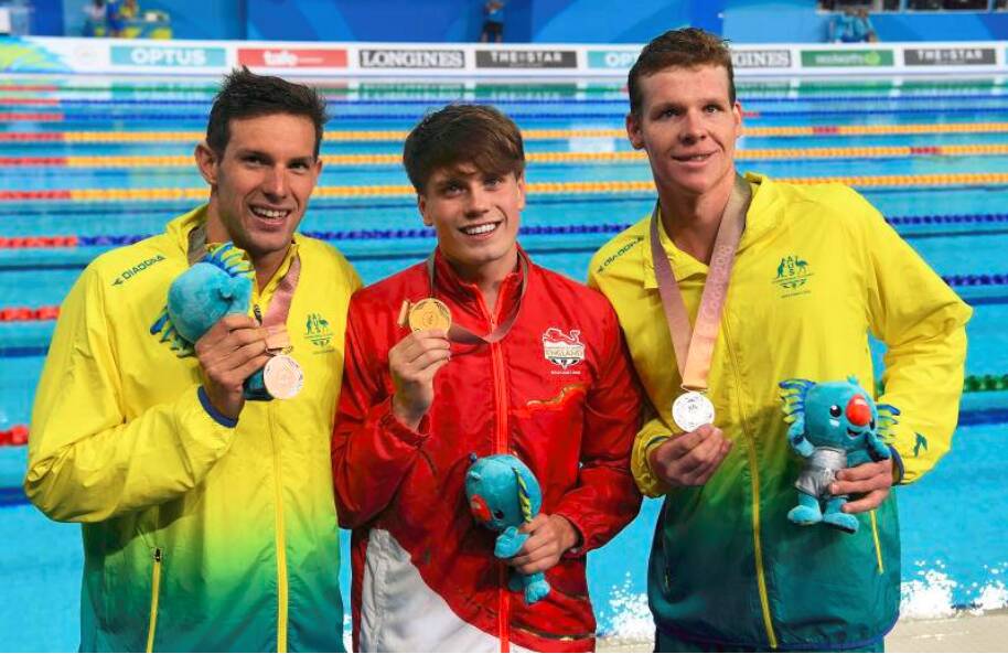 CHAMPIONS: Daniel Fox, England's Thomas Hamer and  Liam Schluter pose for photographs after podium wins in the mens S14 200m freestyle final on day one of swimming competition at the XXI Commonwealth Games at Gold Coast Aquatic Centre. Photo: Dave Hunt