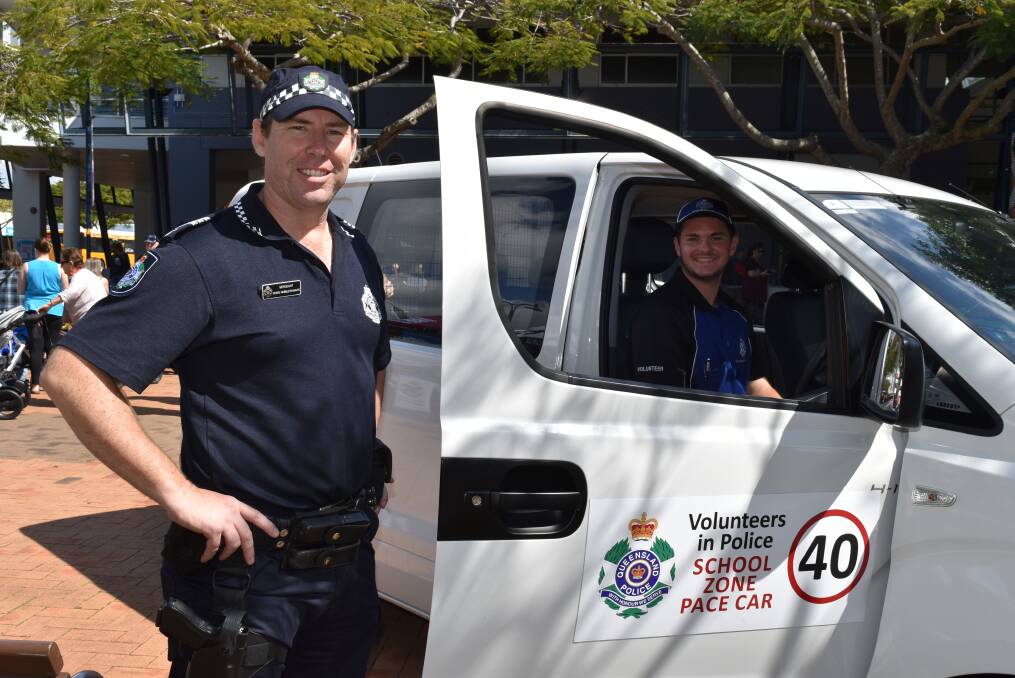 ROAD SAFETY: Bayside patrol crime prevention coordinator Sergeant Chris Hebblethwaite with Volunteer in Policing recruit Sam Zensche, who is behind the wheel of a school zone pace car. Photo: Hannah Baker