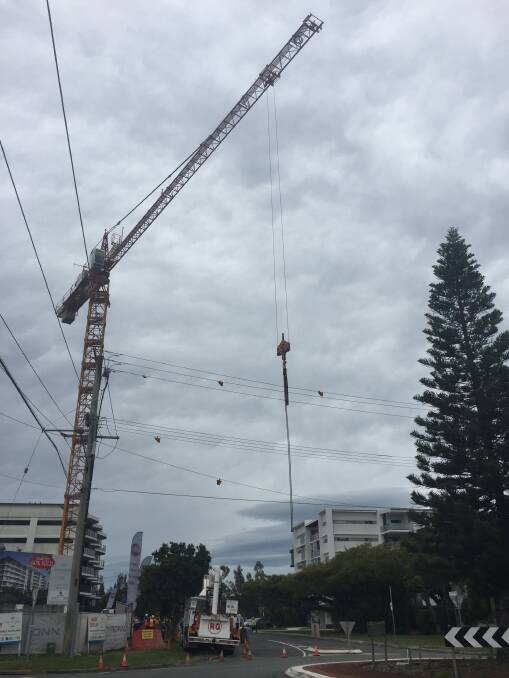 POWER OUTAGE: A crane on a construction site at the corner of Middle and Fitzroy streets hit nearby powerlines, causing more than 1100 customers in the Cleveland area to lose power about 11.30am. Photo: Cheryl Goodenough