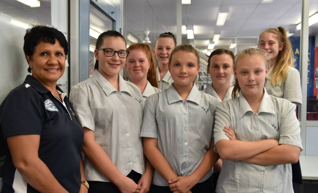 Students at Victoria Point State High School with Indigenous support worker Aunty Robyn Lucas. Students from left are Searne  Solway, 12, Alexandria Blewitt, 12, Kyala Koppenol, 11, Jemma Thom, 12. From back left: Amilea Alden, 13, and Emily Brock, 16. Photo: Hannah Baker 