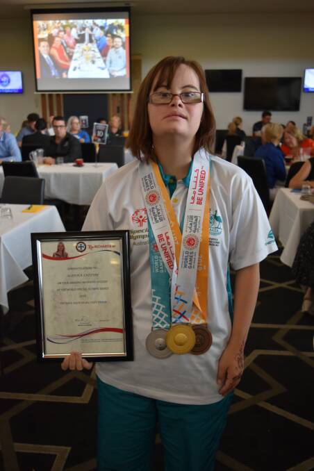 SPORTING PROWESS: Aliesha Sneesby with her Special Olympics World Games medals earned in Dubai at Redlands Community Breakfast. She also holds a certificate of achievement from Redlands MP Kim Richards. Photo: Hannah Baker