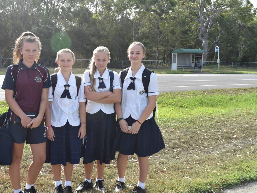 SCHOOL KIDS: Mia Hymas, 14, Ella McNamara, 11, Maddison Hymas, 12, and Zoe McNamara, 13, who all catch the bus from school, must cross the 80km/h Cleveland-Redland Bay Road near the Anita Street intersection to get home. The bus stop is pictured in the background. Photo: Hannah Baker