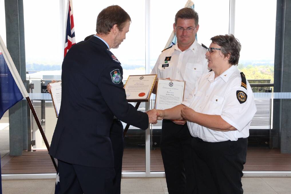 BRAVERY AWARDED: Assistant Commissioner Peter Crawford awards Redland Bay Coast Guard volunteers Jason Boon and Salli Chapman with certificates of appreciation for their efforts during ex-tropical Cyclone Debbie in April 2017. Also awarded but absent during the ceremony was Allan Bell.